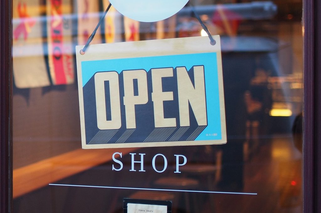 A sign reading Open Shop is displayed prominently in a window, inviting customers inside